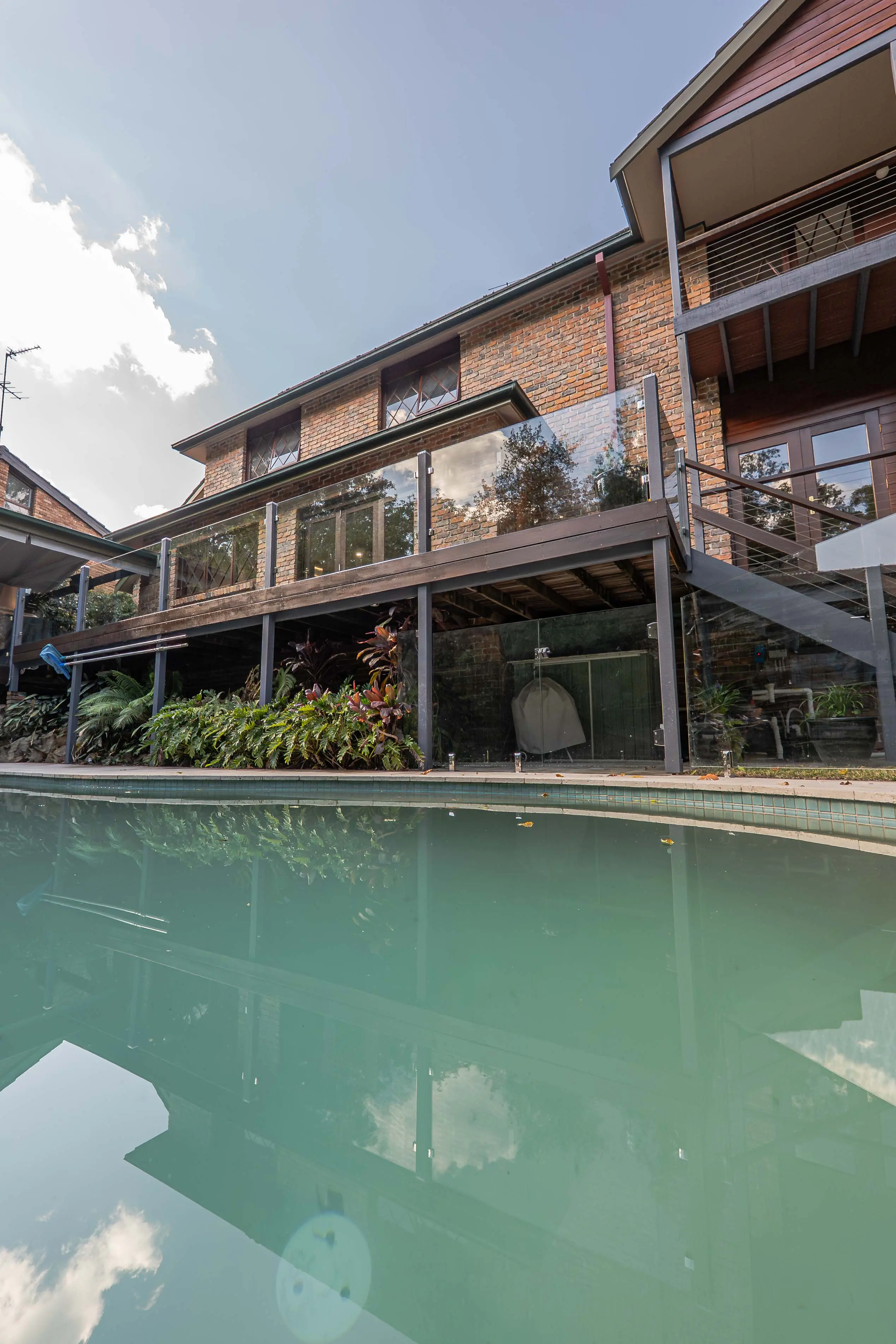 Curved pool house glass balustrade.