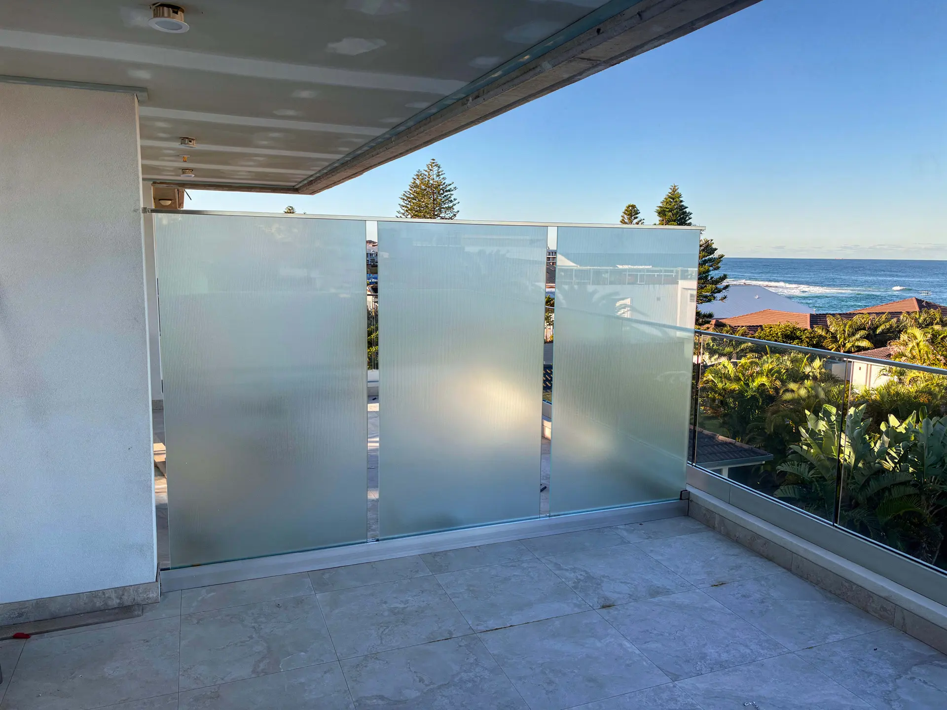 Frosted glass privacy screen ocean view.
