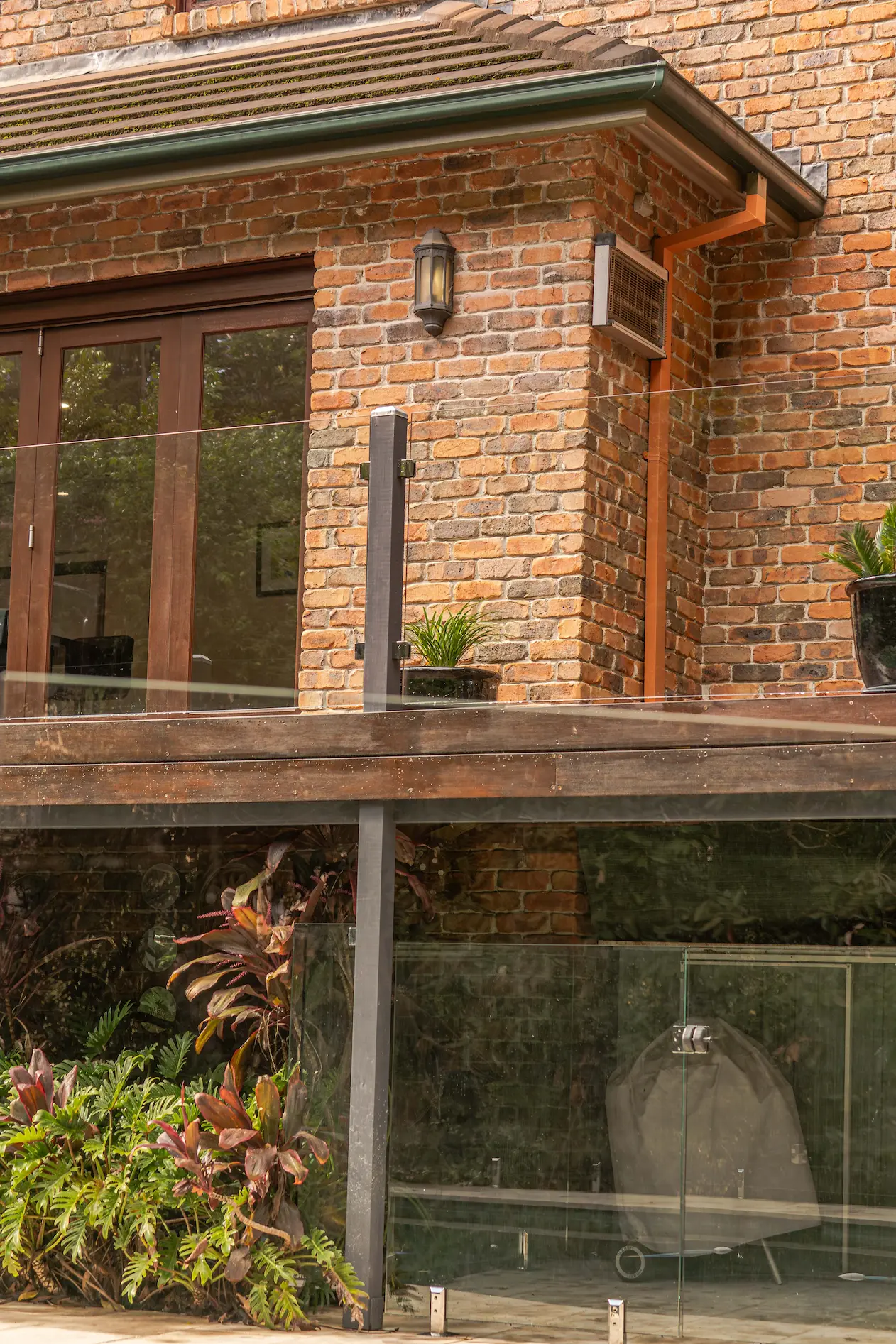 Glass balustrade brick house.