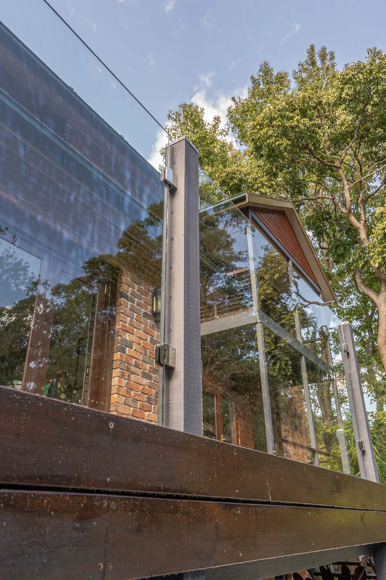 Glass balustrade timber deck reflection.