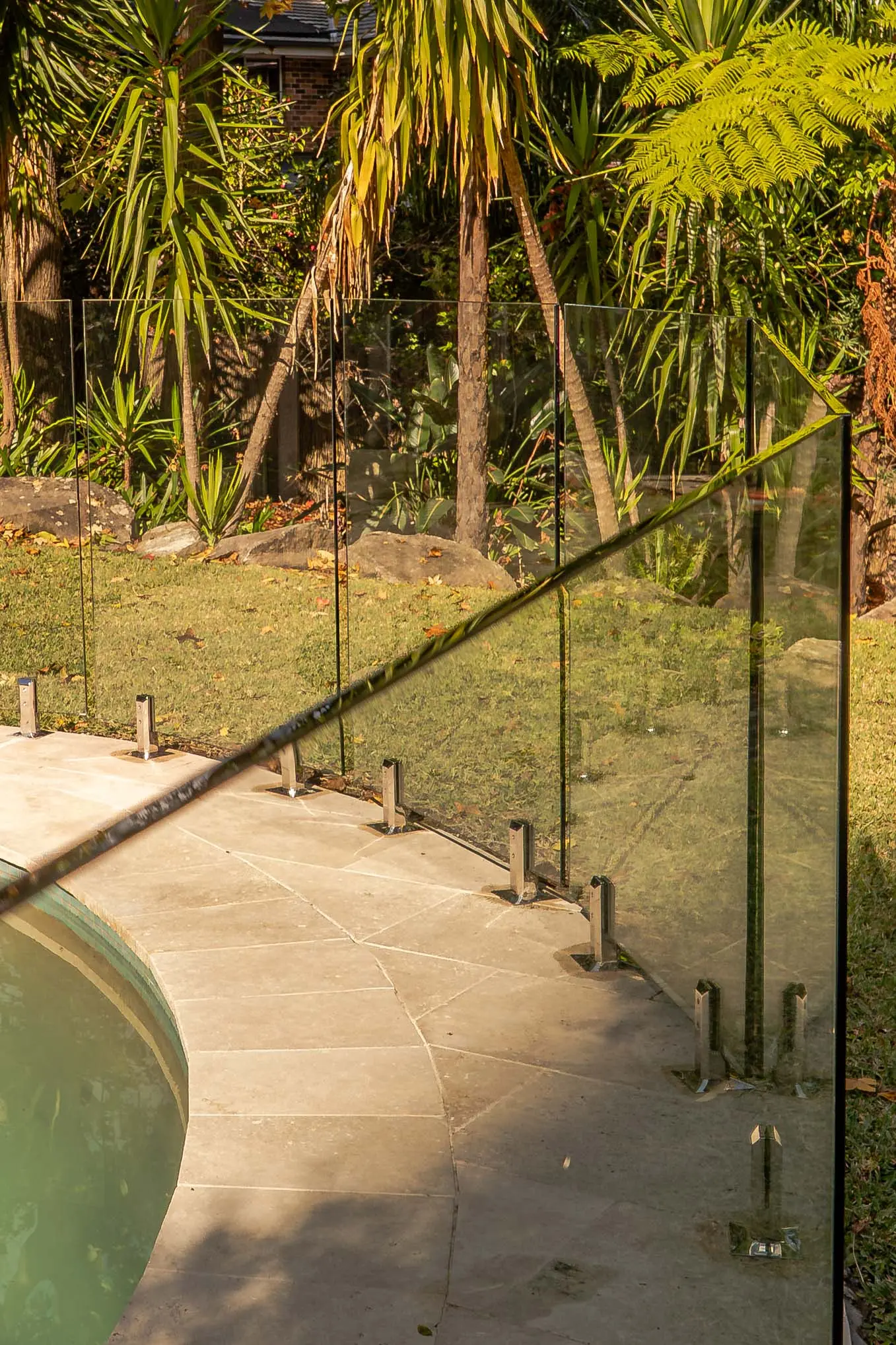 Glass pool fence garden corner.