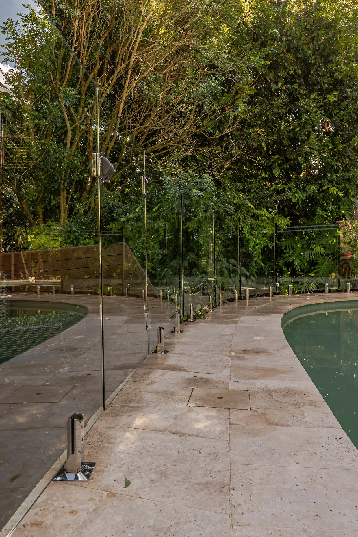 Glass pool fence garden path.