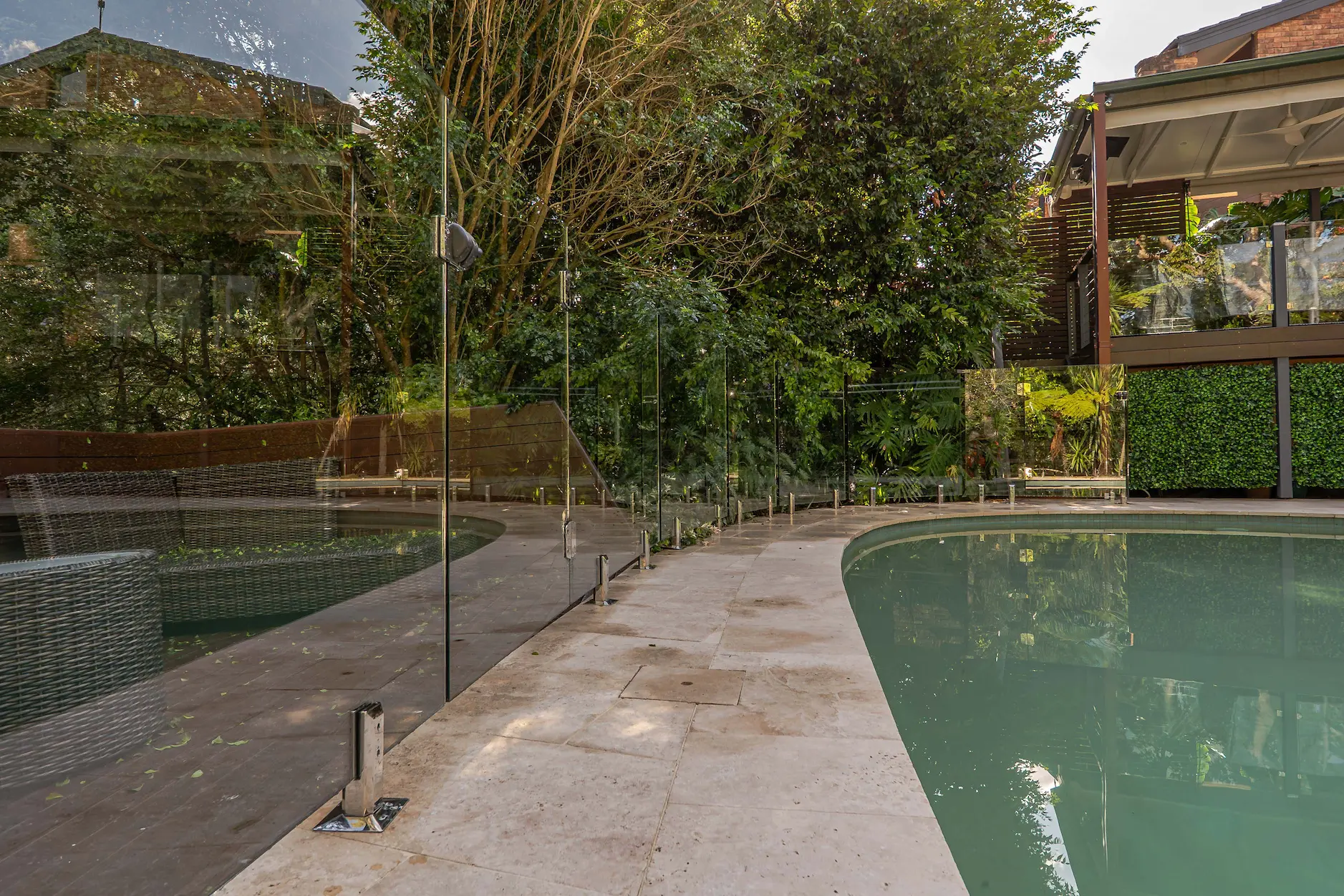 Glass pool fence poolside path.
