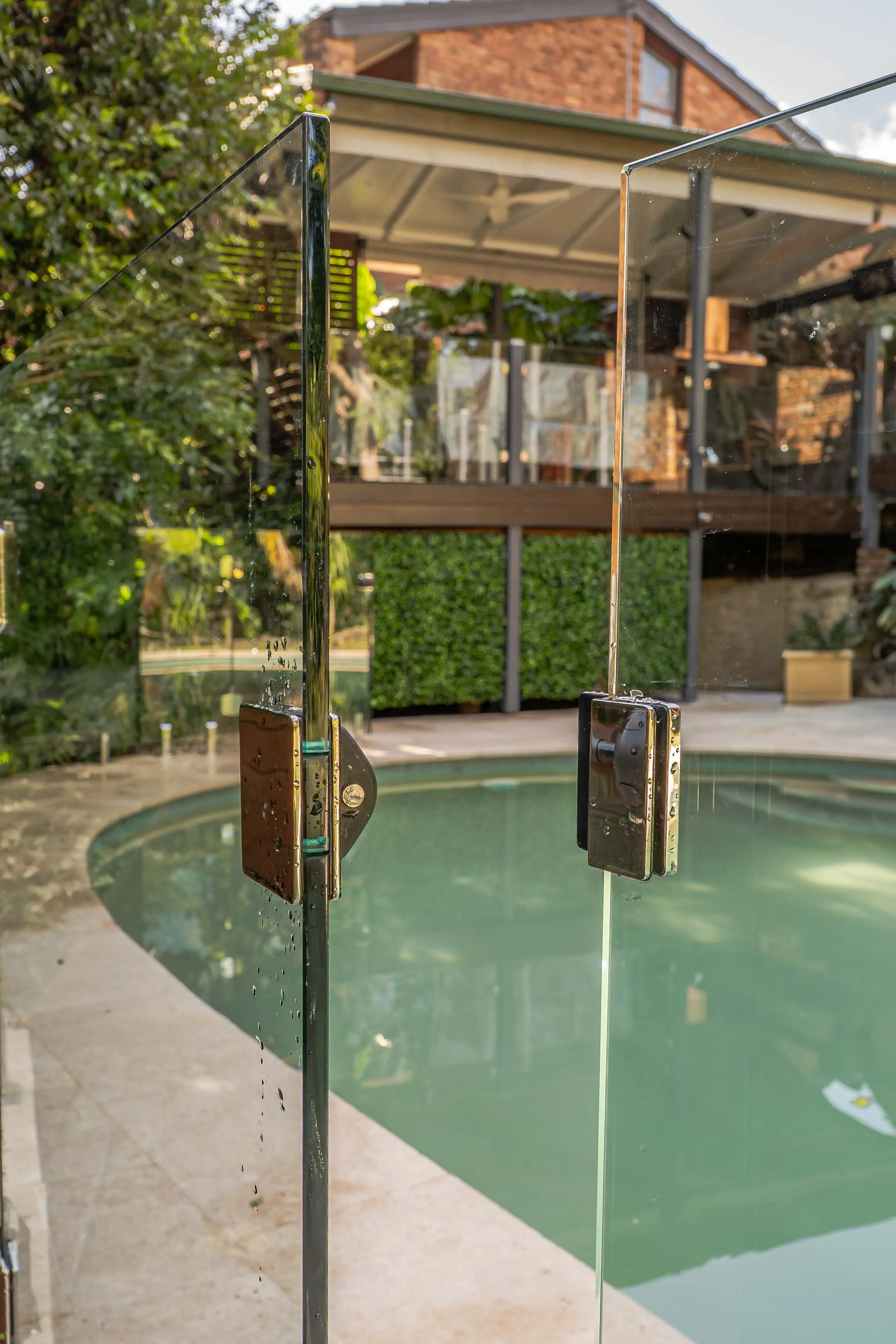 Glass pool gate hinge pool view.