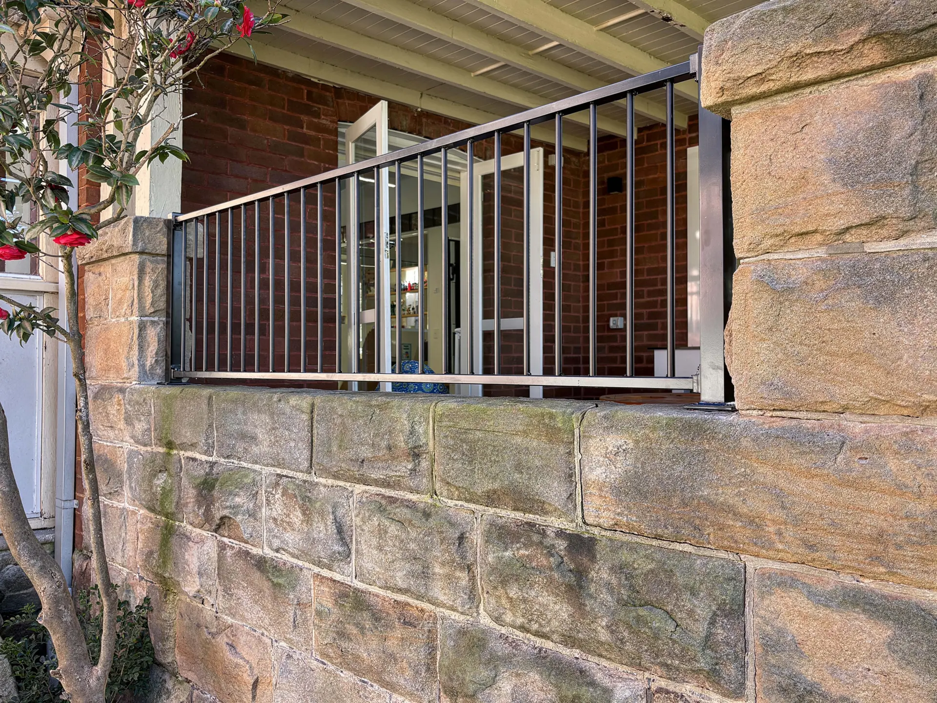 Metal balustrade stone wall detail.