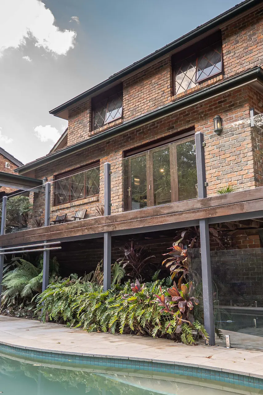 Poolside house glass balustrade portrait.