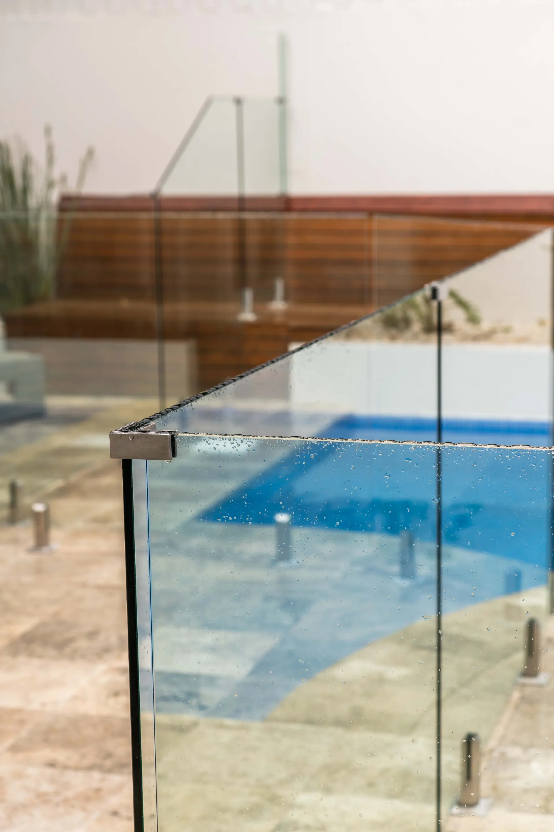 Glass pool fence bench reflection.