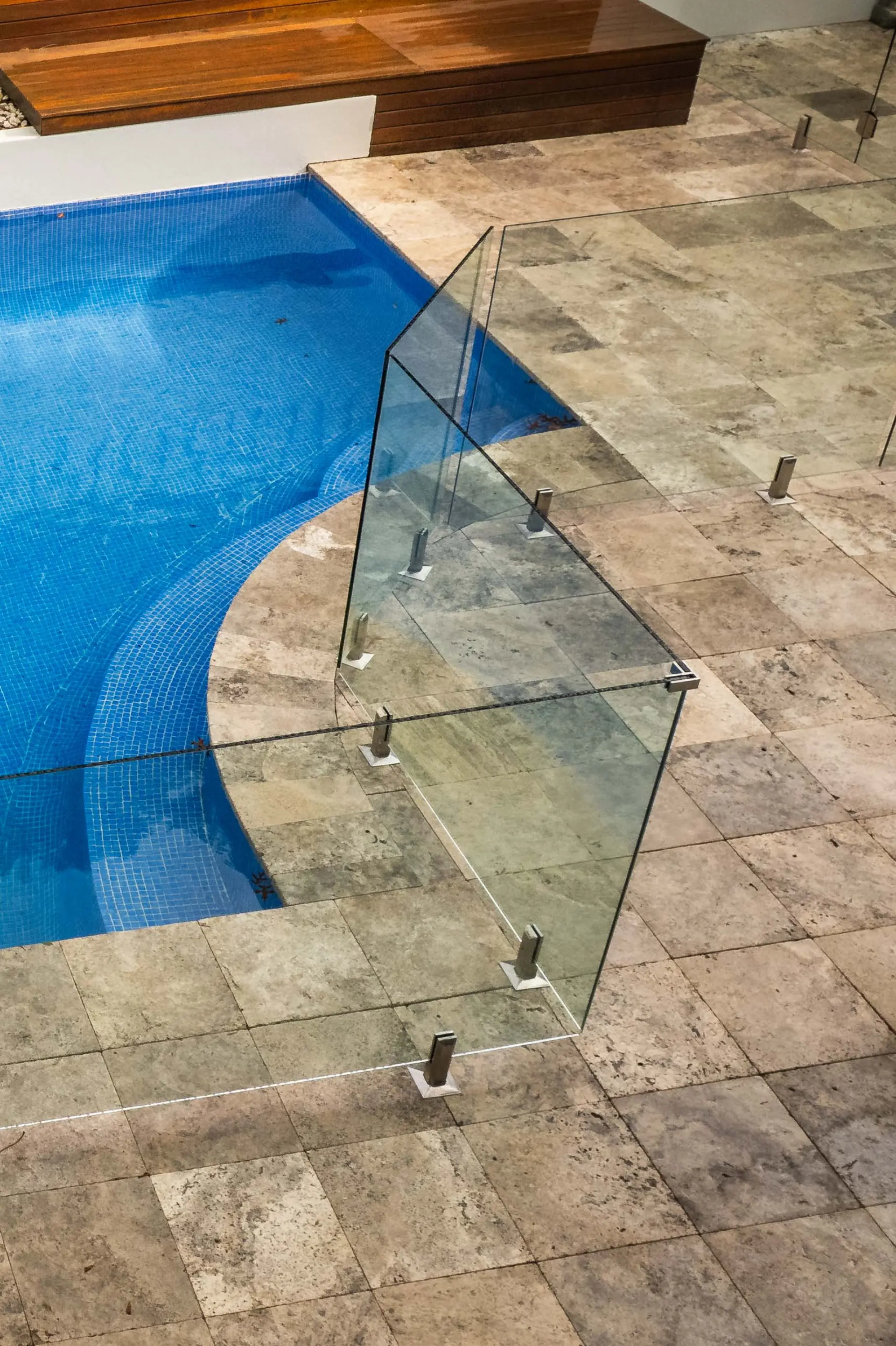 Glass pool fence curved corner overhead.