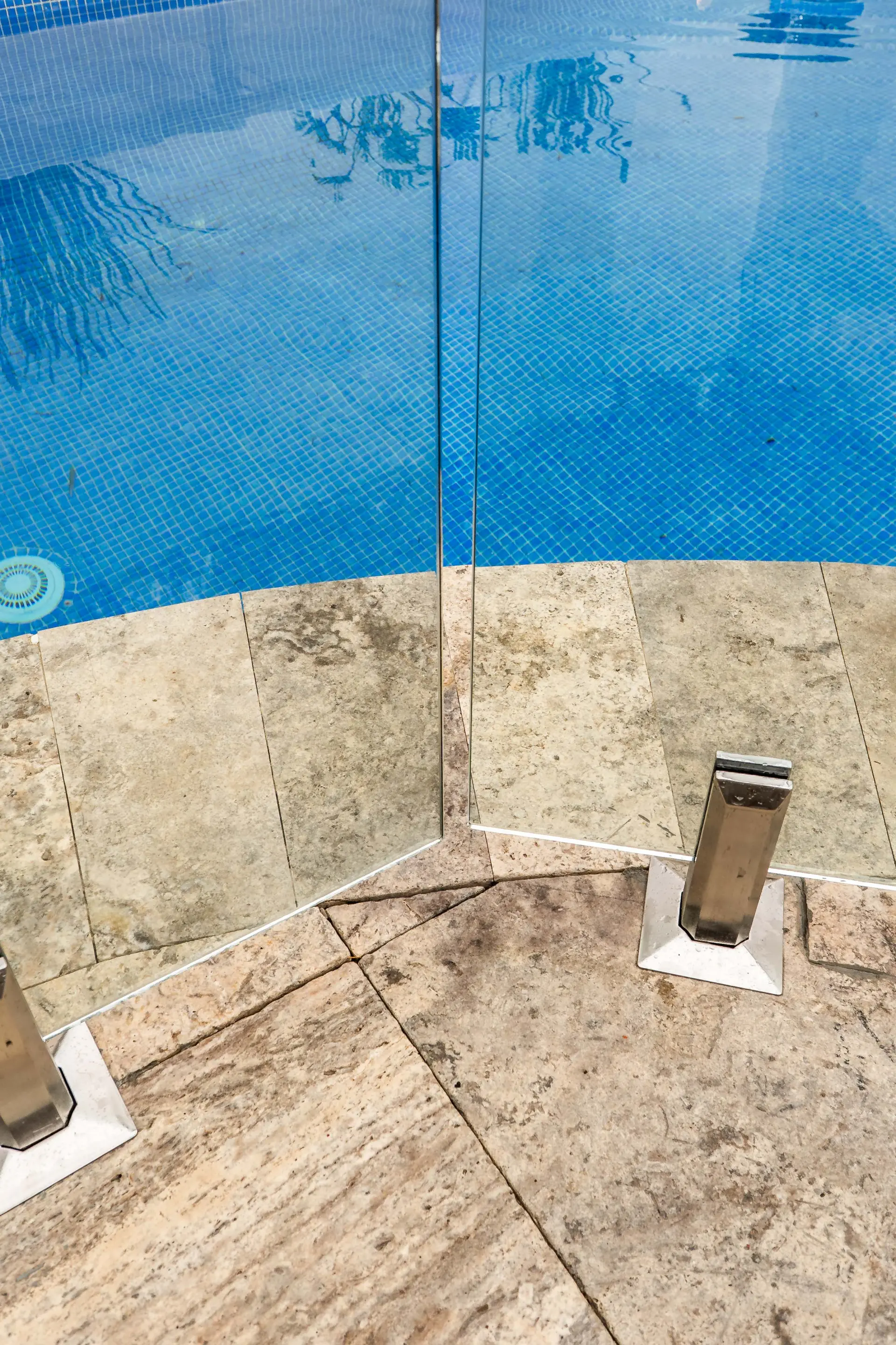 Glass pool fence curved pool overhead.