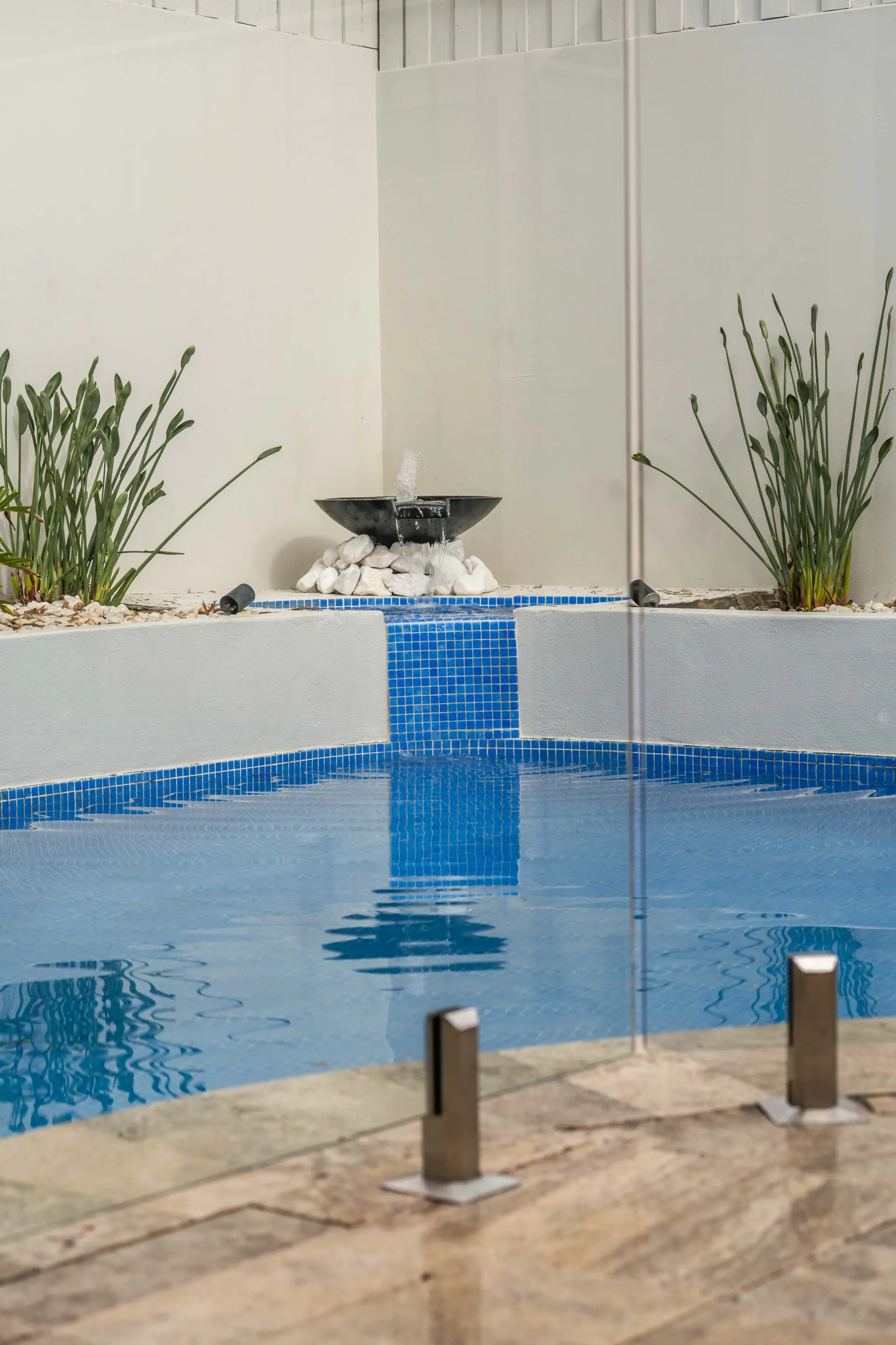 Glass pool fence water feature.