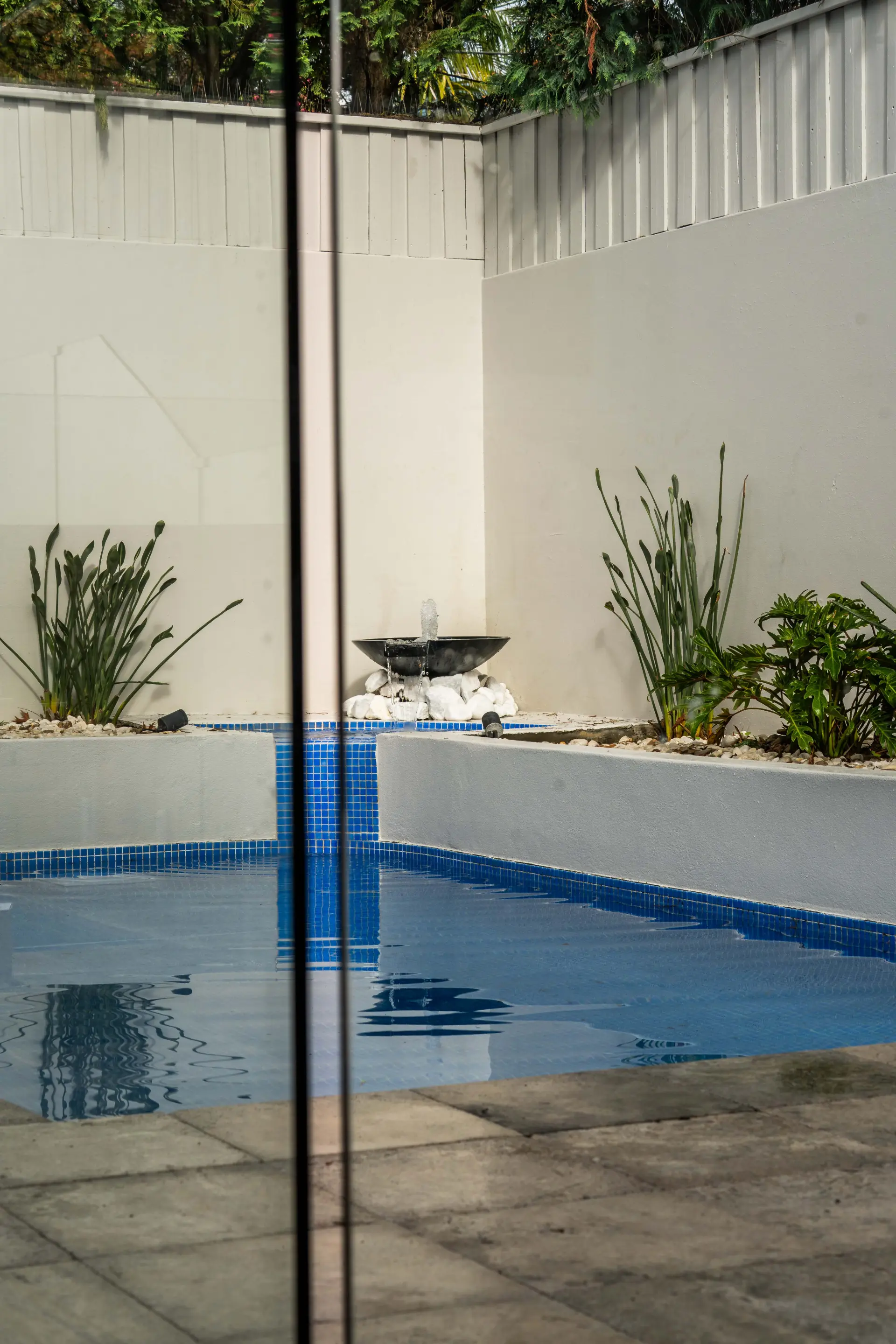 Glass pool fence water feature portrait.